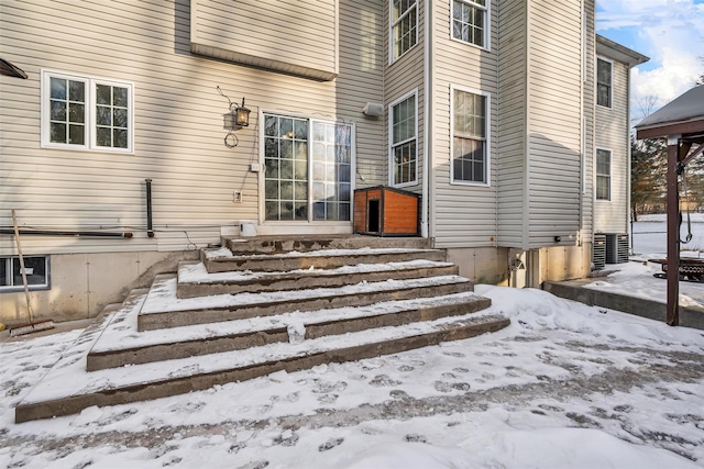 view of snow covered property entrance