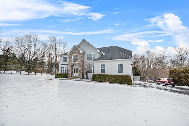 traditional home featuring stone siding