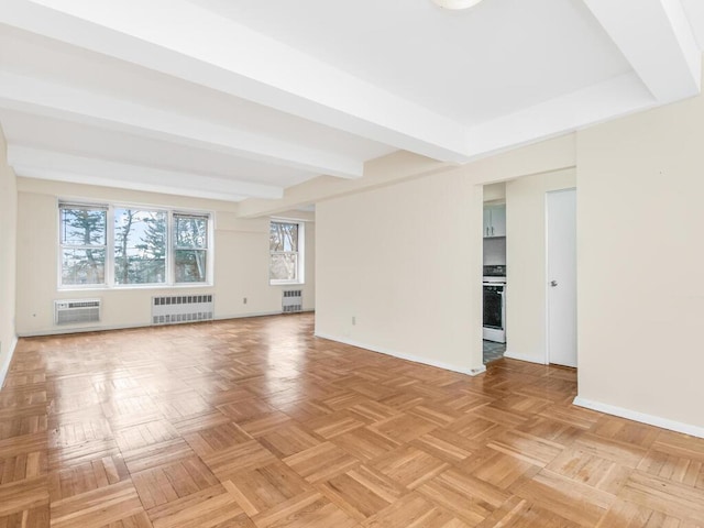 unfurnished room featuring an AC wall unit, radiator heating unit, beamed ceiling, and baseboards