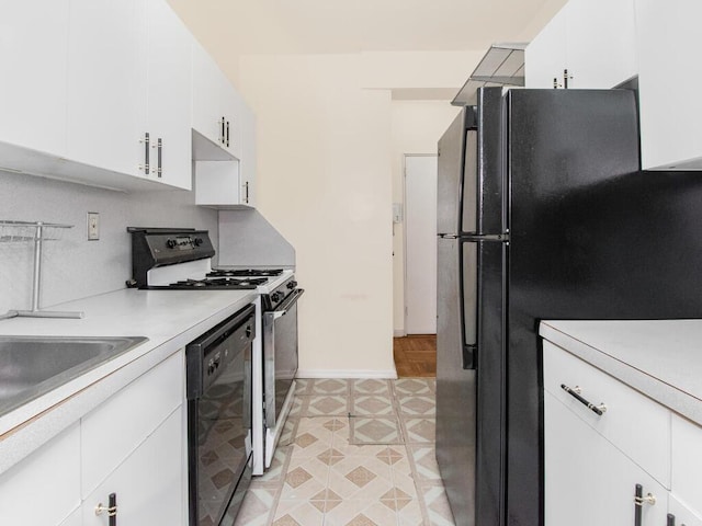 kitchen featuring white cabinets, black appliances, and light countertops