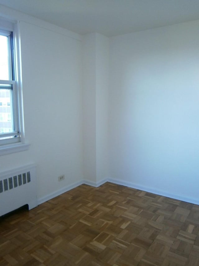 unfurnished room with radiator