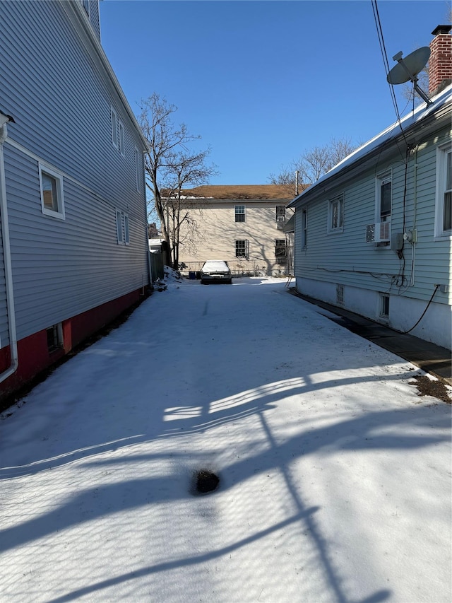 snowy yard featuring driveway