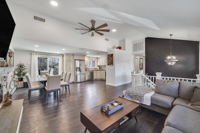 living area featuring recessed lighting, visible vents, dark wood finished floors, and ceiling fan with notable chandelier