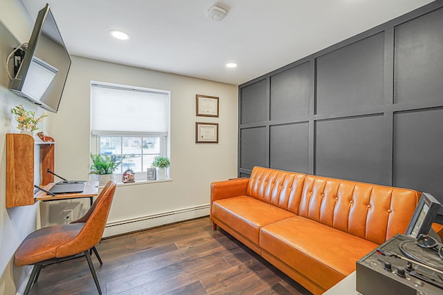 office space featuring dark wood-style floors, baseboard heating, recessed lighting, and a decorative wall