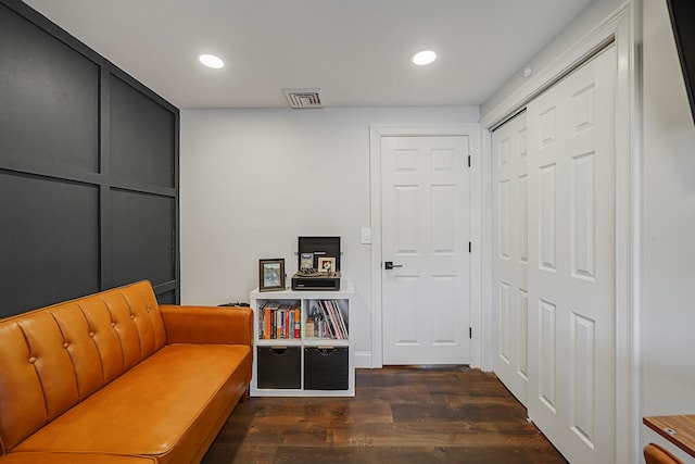 living area featuring dark wood-type flooring, visible vents, and recessed lighting