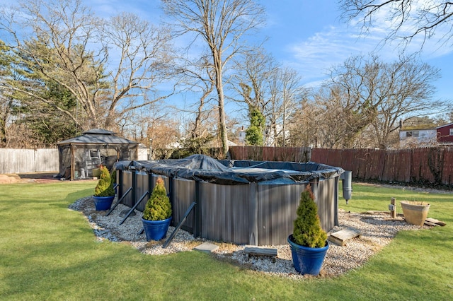 view of pool with a yard, a gazebo, a fenced backyard, and a fenced in pool