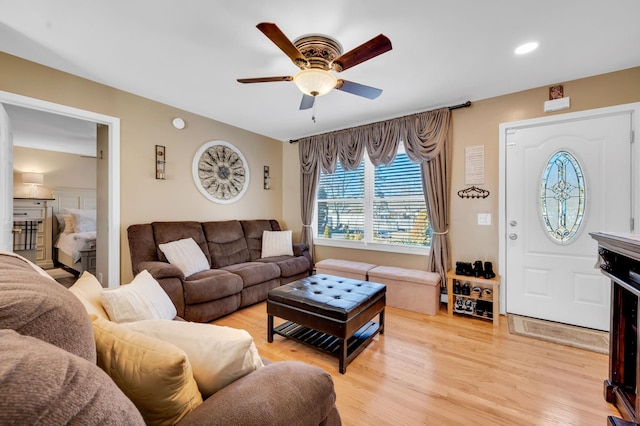 living room with ceiling fan and light wood-style floors