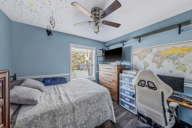 bedroom with a ceiling fan and dark wood-style flooring