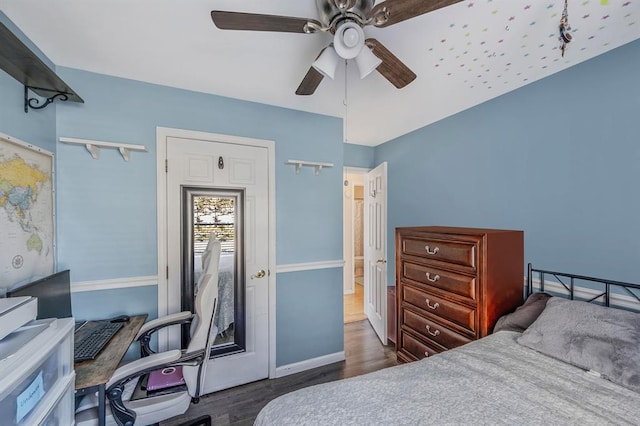 bedroom featuring ceiling fan, dark wood-type flooring, and baseboards