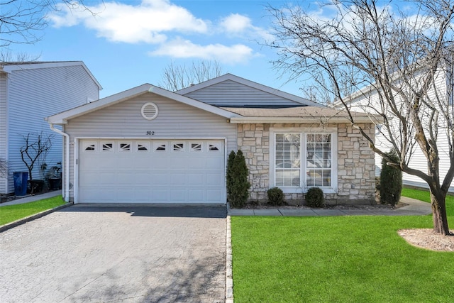 ranch-style home featuring a garage, driveway, a front lawn, and stone siding