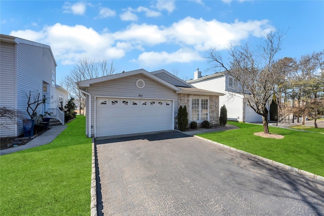 view of front of house featuring a garage, driveway, a chimney, and a front yard