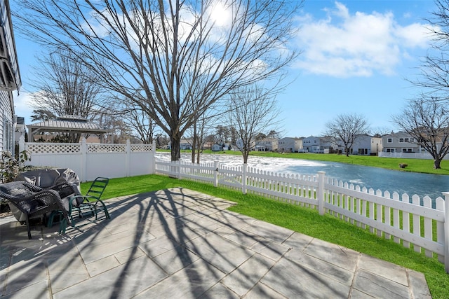 view of patio / terrace featuring fence private yard, a water view, a residential view, and a gazebo