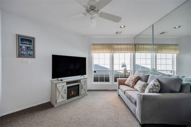 living area featuring light carpet, visible vents, and baseboards