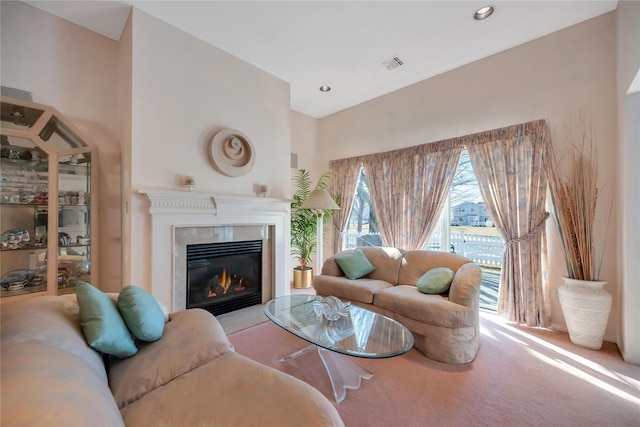 living area with carpet floors, a glass covered fireplace, visible vents, and recessed lighting