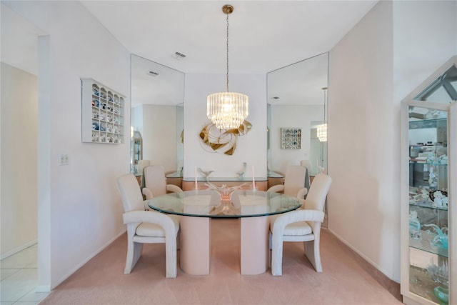 dining room featuring light carpet, a notable chandelier, visible vents, and baseboards