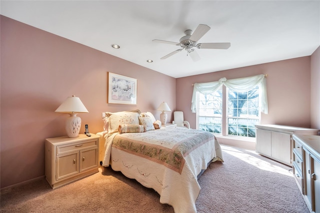 bedroom with a ceiling fan and light colored carpet