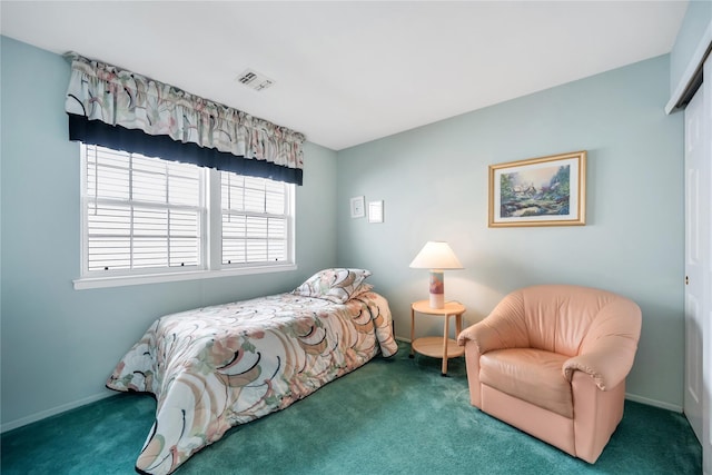 bedroom featuring baseboards, visible vents, and dark colored carpet