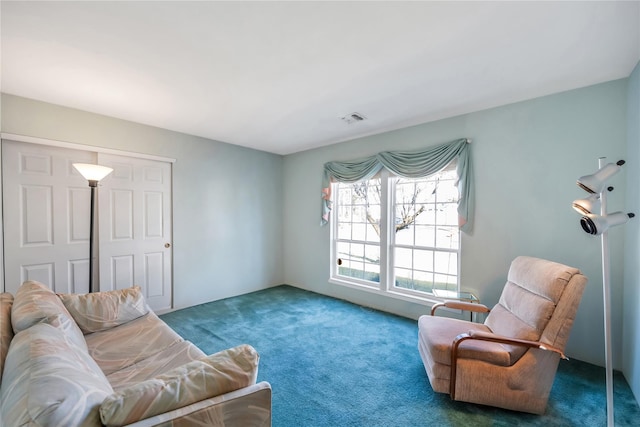 sitting room with dark colored carpet and visible vents