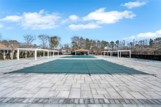 community pool with a gazebo, a patio, fence, and a pergola