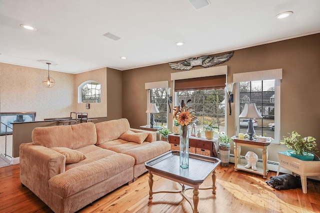 living room with light wood-style floors, recessed lighting, visible vents, and baseboard heating