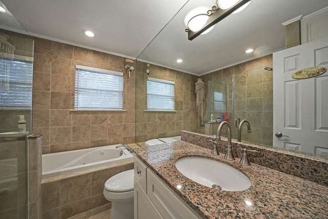 full bathroom featuring tiled bath, toilet, vanity, tile walls, and crown molding