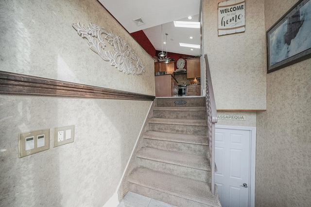 stairway with lofted ceiling, tile patterned flooring, and recessed lighting