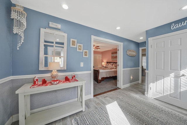 corridor with baseboards, recessed lighting, and light wood-style floors