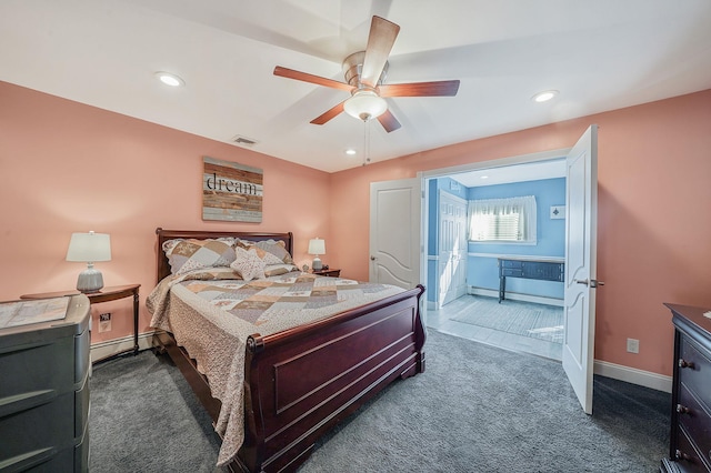 bedroom with dark colored carpet, recessed lighting, visible vents, baseboard heating, and baseboards