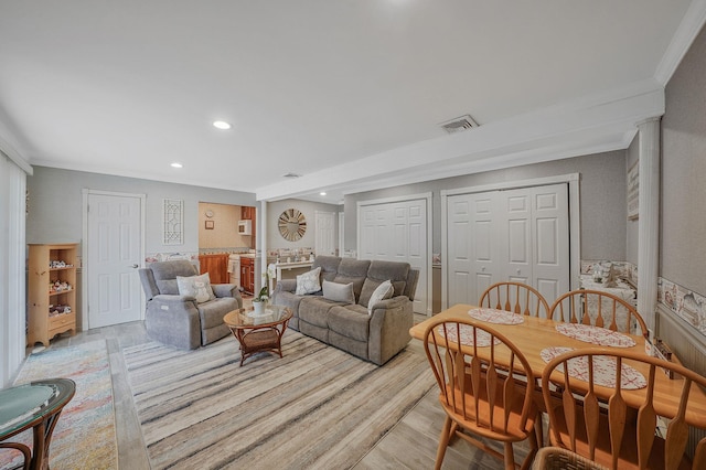 living room with recessed lighting, visible vents, and light wood-style flooring