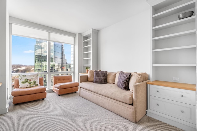 living room featuring built in features, expansive windows, a city view, and light carpet