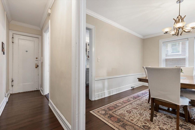 dining space featuring an inviting chandelier, baseboards, dark wood-style flooring, and crown molding