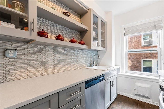 bar featuring a sink, dark wood-type flooring, backsplash, and dishwasher