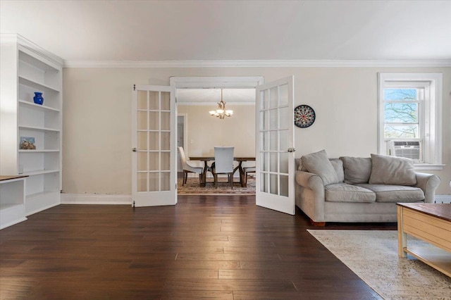 living room with ornamental molding, french doors, hardwood / wood-style floors, and a notable chandelier