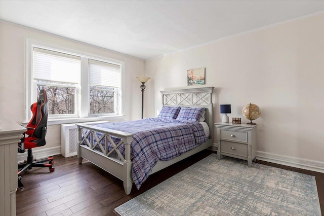 bedroom with wood finished floors and baseboards