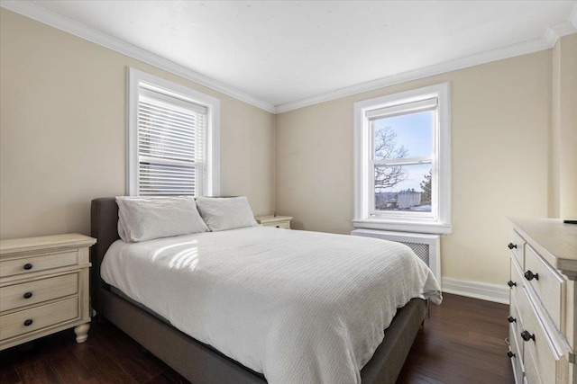 bedroom featuring dark wood-type flooring, ornamental molding, and baseboards