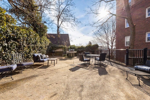 view of patio with outdoor dining area, outdoor lounge area, and fence