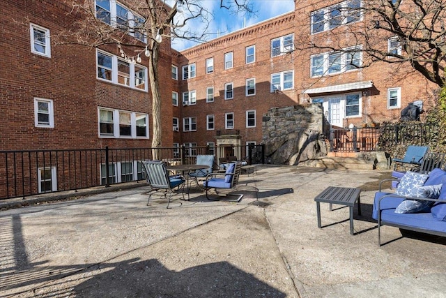 view of property's community featuring a patio area and fence