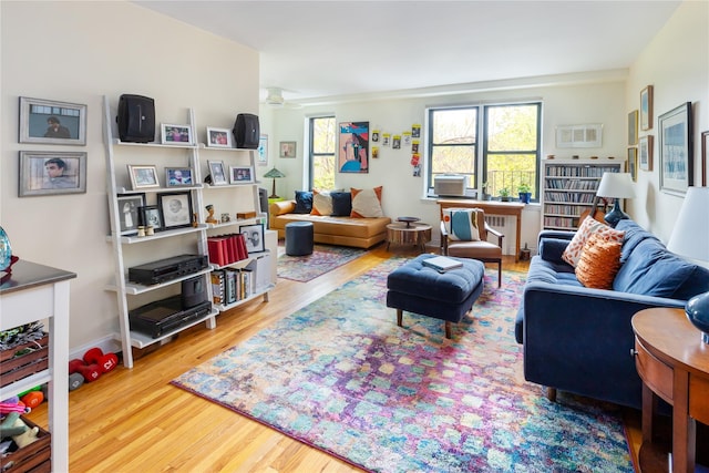 living area featuring cooling unit and wood finished floors