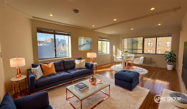 living room featuring recessed lighting, baseboards, and wood finished floors