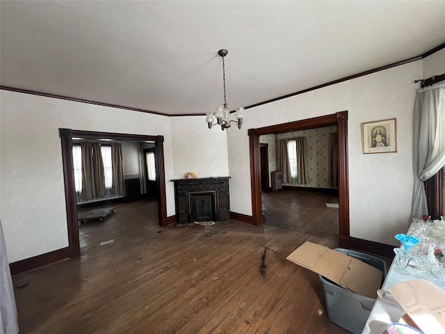 living area with an inviting chandelier, baseboards, ornamental molding, and dark wood finished floors