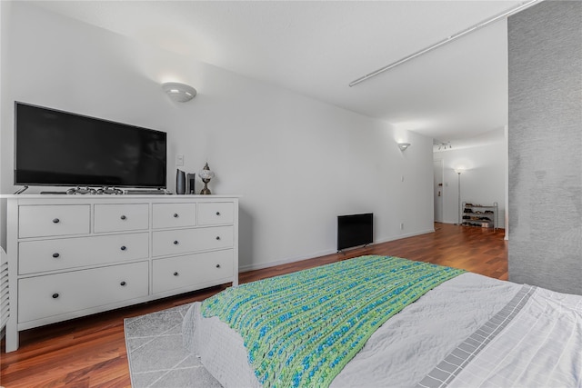 bedroom featuring dark wood finished floors