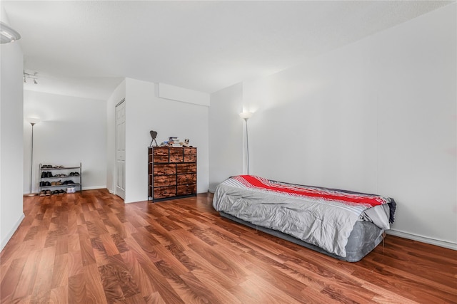 bedroom with a closet and wood finished floors