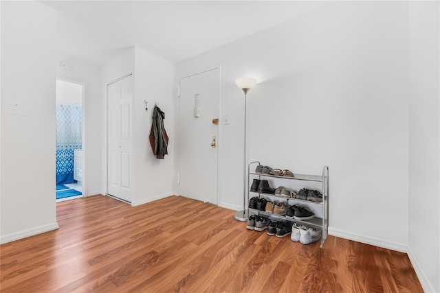 interior space featuring wood finished floors and baseboards