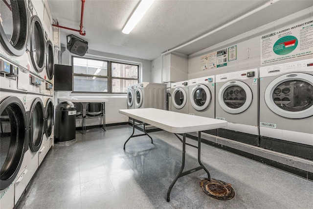 community laundry room with stacked washer and clothes dryer, a textured ceiling, and separate washer and dryer