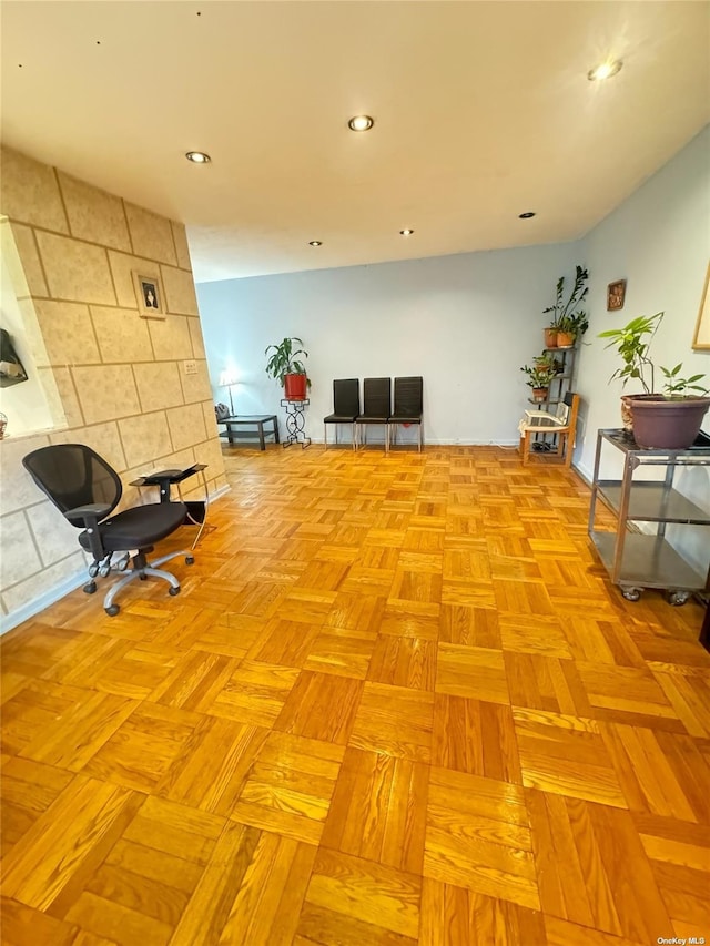 miscellaneous room with an accent wall and recessed lighting