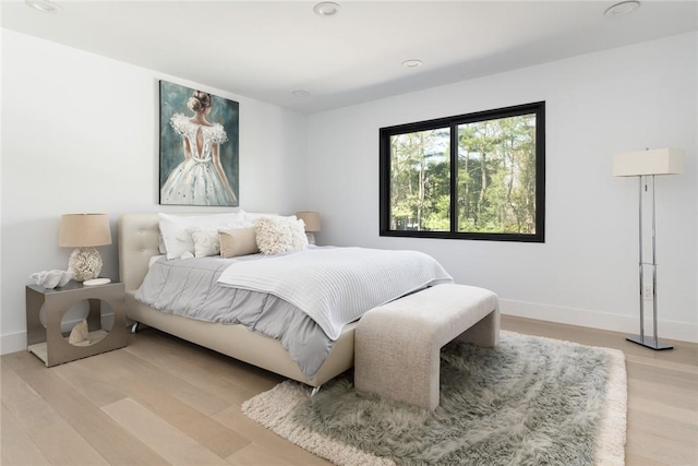 bedroom featuring light wood-style flooring and baseboards