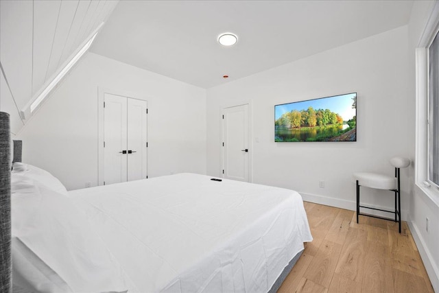 bedroom featuring light wood-style flooring and baseboards