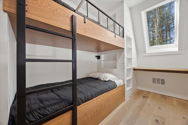 bedroom featuring light wood finished floors and visible vents