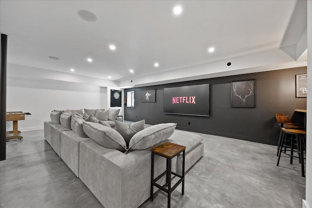 cinema room with concrete flooring, recessed lighting, and baseboards