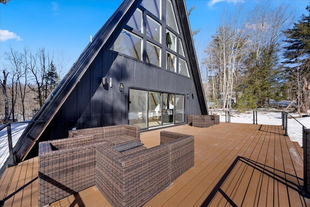 snow covered deck with an outdoor living space